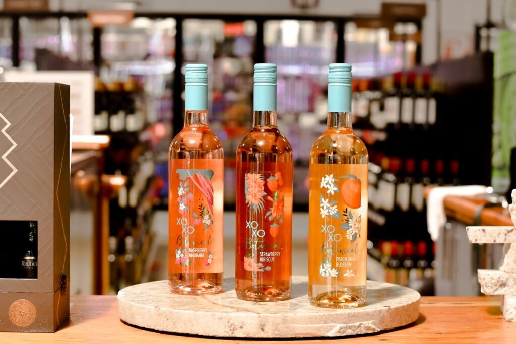 Cata de Vinos y Maridajes - clear glass bottles on brown wooden table