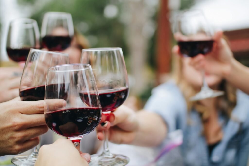 Cata de Vinos y Maridajes - people tossing their clear wine glasses