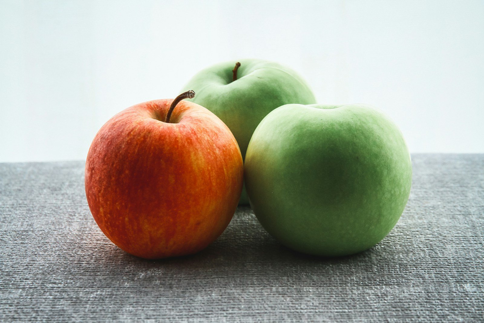 Manzana - three green and red apple fruits